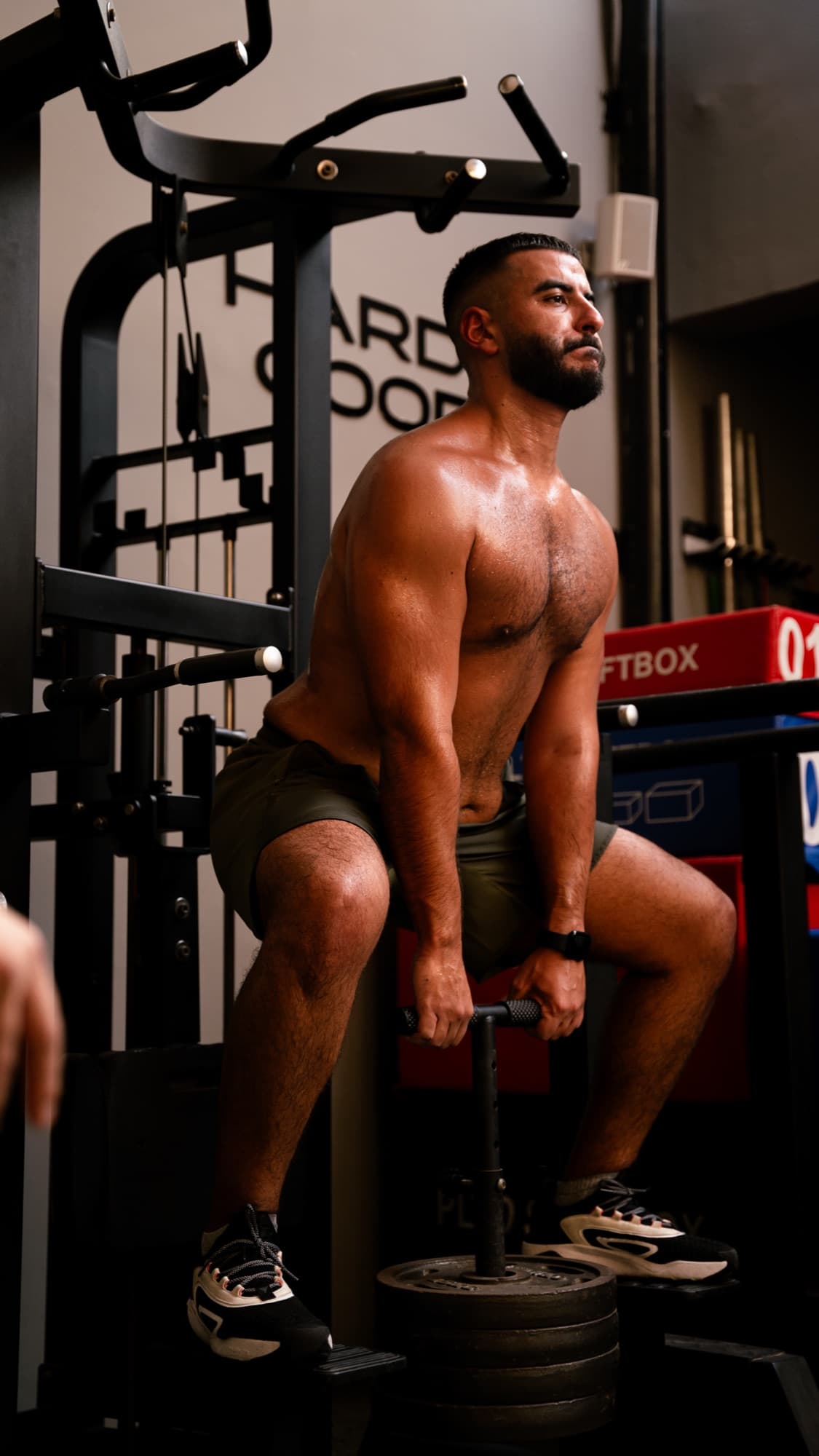 Athlete seated at a squat rack at Youskilled