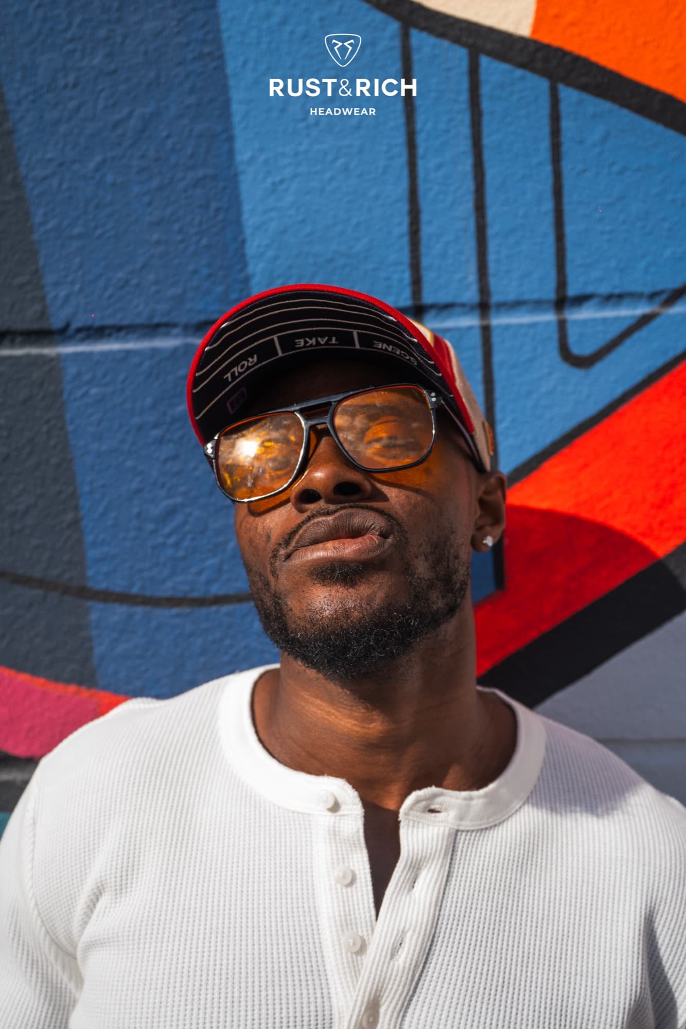 Rust and Rich campaign portrait in a cap and glasses